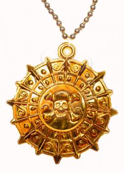 Gold medallion with skull and crossed bones isolated