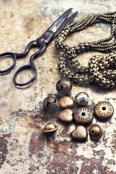 Set of beads and chains for crafts located on metal background