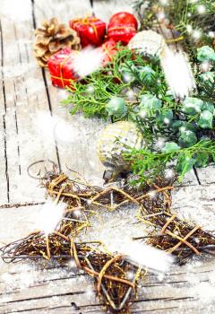 Woven wire Christmas star on wooden background with snow