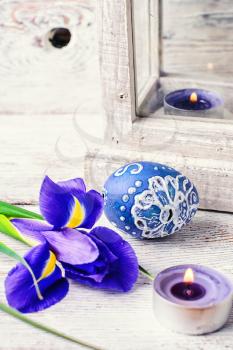 Decorated with painted Easter eggs and flowers  iris on light background