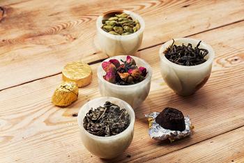 range of different varieties of tea leaves on wooden background