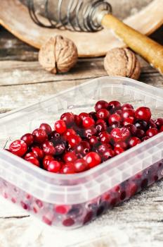 cranberries in a plastic box on the kitchen table