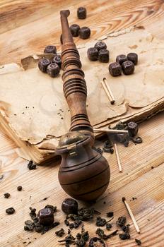 Smoking pipe in a retro style,dark chocolate wooden background