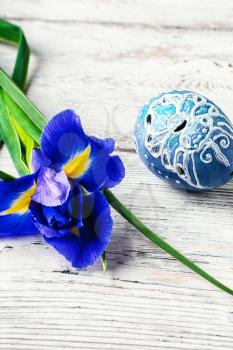 Iris flower painted and decorated Easter egg on light background