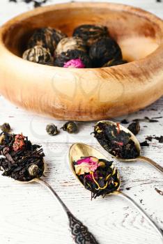 Set of different varieties of oriental tea on bright wooden background