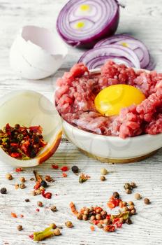 dish with raw minced beef with egg yolk and spice