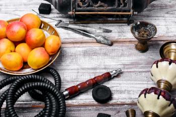 Details Eastern smoking hookah with fruit apricot