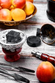 Details Eastern smoking hookah with fruit apricot
