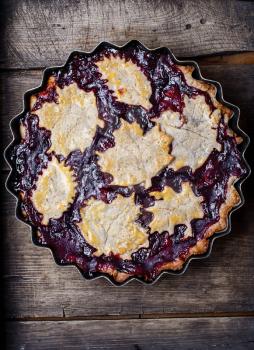 Autumn pie with plum decorated cakes in the form of leaflets