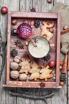 Gingerbread cookies and cup of coffee with christmas decoration in wooden retro box