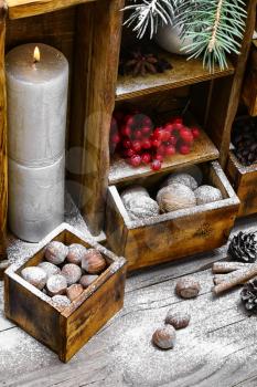 Decorative sideboard decorated with nuts,candle and snowball for Christmas