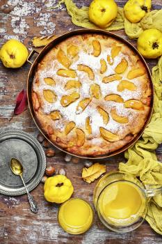 Autumn pie with ripe fruits of quince in a rustic style