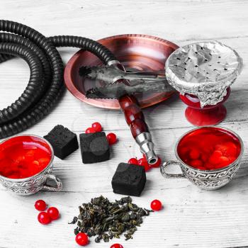 arabic hookah and tea with berries on white background