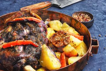 Mutton cooked in a pan with potatoes and vegetables