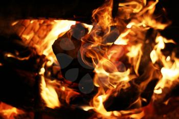 Burning log fire. Night fireplace. Closeup flame. Barbecue coal blazing
