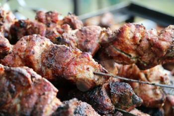 Cooked shish kebab barbecue meat on skewer. Hot grill food