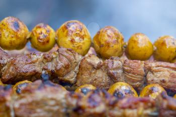 Barbecue kebab cooking. Tasty grill potatoes dinner cook. Food BBQ background. Roasted fresh beef meat