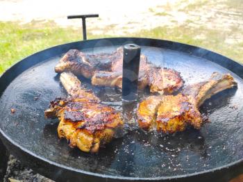 Three steaks are fried in their own juice on pan. Summer season hot food