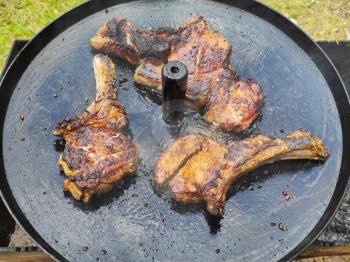 Three steaks are fried on pan. Summer season hot food