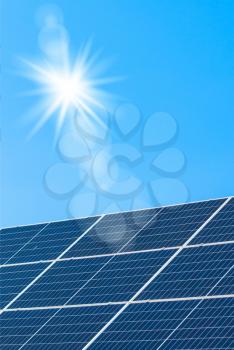 Sun make green energy with solar panels on blue sky background. Sunlight clean energy power. Renewable green cheap electricity