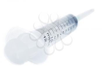 Plastic syringe isolated on a white background, high depth of field, close-up studio shot