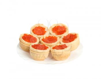 Red caviar in tartlets on plate, isolated on white background, studio shot