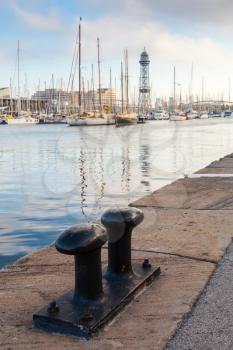 Port of Barcelona, Spain. Big black steel bollard on the coast