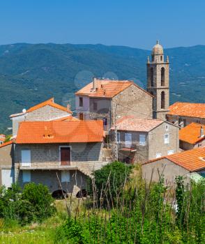 Small Corsican village landscape, old living houses and bell tower. Petreto-Bicchisano, South Corsica, France