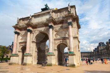 Paris, France - August 7, 2014: Triumphal Arch (de Triomphe du Carrousel) in front of  the Louvre museum. Paris, France