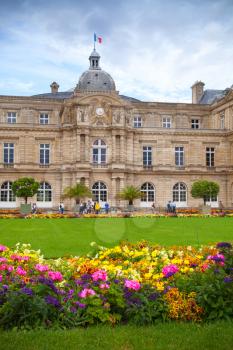 Paris, France - August 10, 2014: Luxembourg Palace and colorful flowers of the Luxembourg Garden in Paris