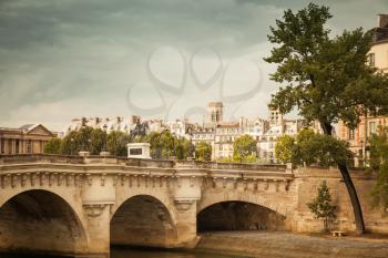 Pont Neuf. The oldest bridge across the Seine river in Paris, France. Vintage stylized photo with filter effect