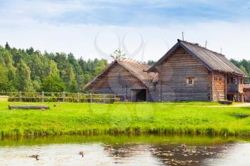Russian wooden architecture example, old rural houses on the lake coast