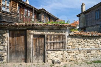 Street with stone walls and wooden builds in ancient town Nessebur, Bulgaria