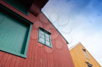Fragment of red and yellow wooden houses in Norway