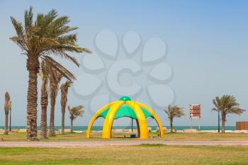 RAHIMA, SAUDI ARABIA - MAY 10, 2014: Palms and arbor on the coast of Persian Gulf