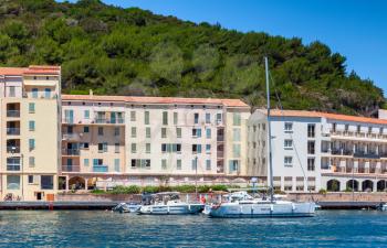 Yachts moored near embankment of Bonifacio, small resort port city of Corsica island in sunny summer day, Corse-du-Sud, France