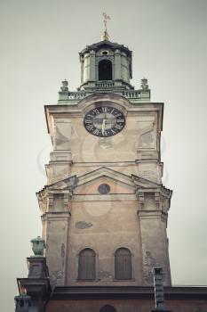 Storkyrkan, close-up of its tower, the oldest church in Gamla stan, the old town in central Stockholm, Sweden. Vintage toned photo with retro filter effect