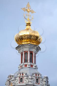 Golden dome with cross. Old Orthodox Church of the Nativity in St.Petersburg, Russia