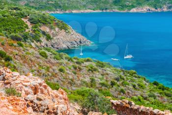 Coastal summer landscape of South Corsica, sailing yachts moored in azure bay