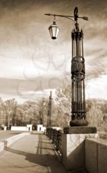 Street lanterns on the bridge in Saint-Petersburg, Russia. Vintage stylized photo.