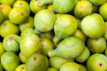 Green figs lay on the counter of street food market on Madeira island, Portugal. Close up photo with selective focus