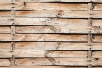 Uncolored wicker wooden wall, close up background photo texture
