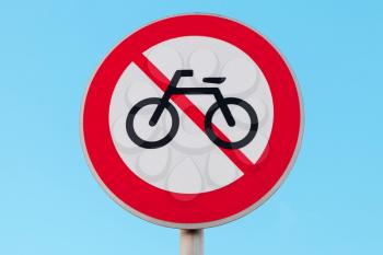 No bikes. Round road sign over blue sky background