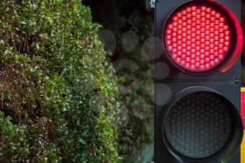 Modern LED traffic lights with red stop signal, close up photo