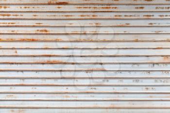 Old gray rusted corrugated metal wall, frontal background photo texture