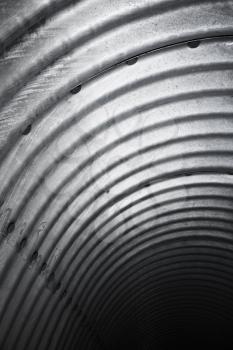 Abstract industrial interior background, corrugated tunnel, vertical photo