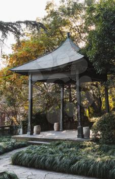 Traditional Chinese wooden gazebo on the coast of West Lake, popular public park in Hangzhou, China