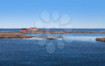 Rural Norwegian landscape, traditional red wooden houses on rocky islands