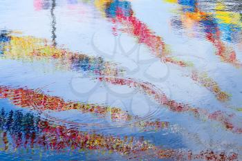 Colorful stripes reflections, ripple water surface. Abstract background photo