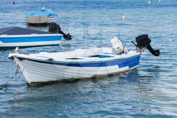 White wooden fishing motor boat anchored in port of Zakynthos, Greek island in the Ionian Sea